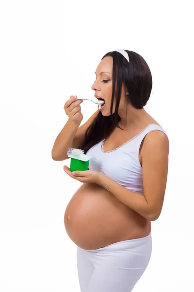 Pregnancy. Health. Pregnant woman eating yogurt. — Stock Photo, Image