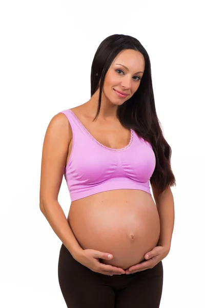 Hermosa morena embarazada abrazando barriga. Embarazo deportivo, saludable y feliz — Foto de Stock