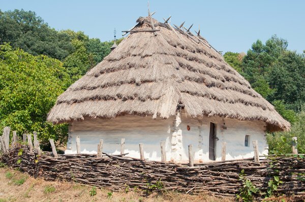 National Museum of Folk Architecture and Life Pirogovo. Traditional wattle and daub hut with thatched roof