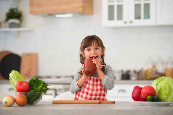 Cute Little Girl Pigtails Checkered Culinary Apron Eating Sausage Kitchen — Stock Photo, Image