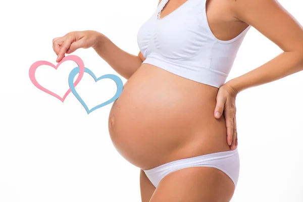 Pregnant belly with blue and pink heart. Horizontal closeup. Determine the sex of the child: twins, girl or boy.