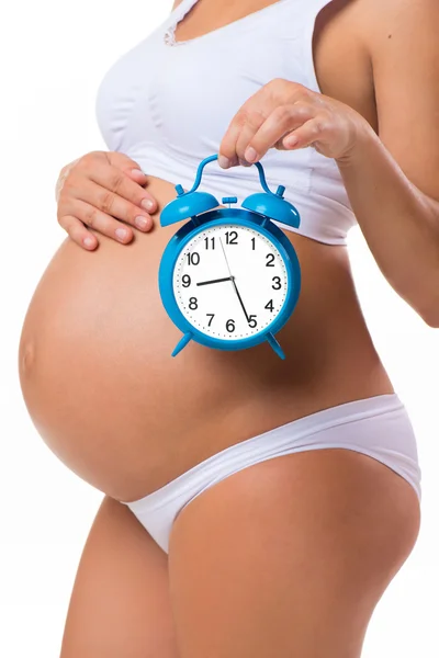 Soon birth. Pregnant belly with alarm clock. Conceptual image of happy pregnancy. — Zdjęcie stockowe