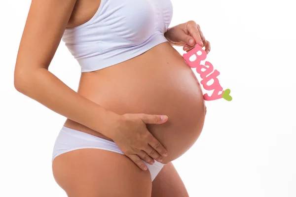 Barriga grávida com inscrição rosa para menina. Mulher grávida à espera de uma filha. Close-up horizontal isolado sobre fundo branco . — Fotografia de Stock