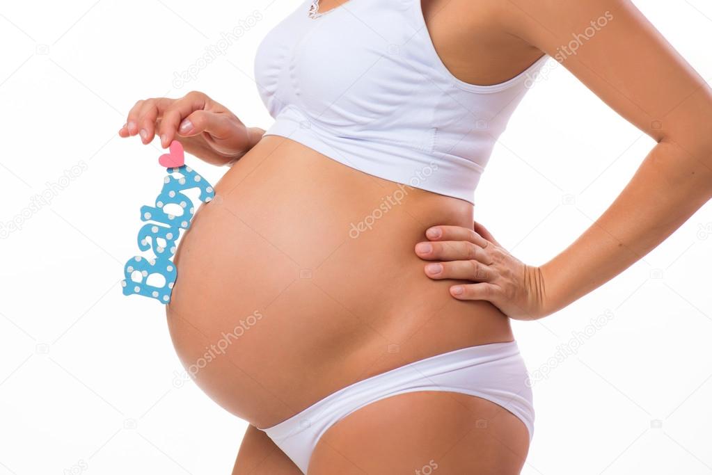 Pregnant belly with blue and pink heart. Horizontal closeup. Determine the child: twins, girl or boy.