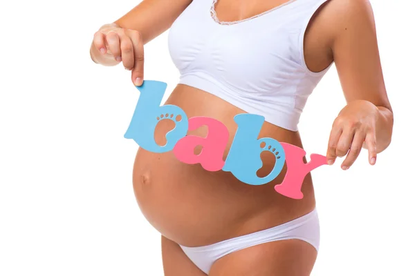 Těhotenství. Mateřství. Modré a růžové slovo dítě u těhotné bříško. Dvojčata, holka nebo kluk. — Stock fotografie