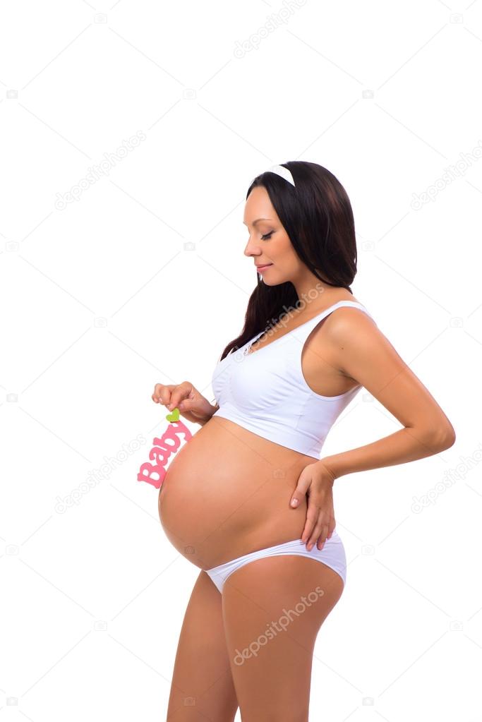 Beautiful pregnant woman holding near tummy pink sign Baby for newborn girl