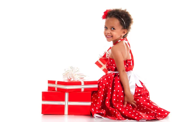 Merry mulatto girl with curly hair and red gift boxes. Shopping, presents, holiday, congratulations — Stock Photo, Image