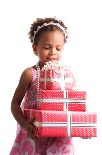 Give presents! Curly mulatto girl with gift boxes in hands on a white background. — Stockfoto