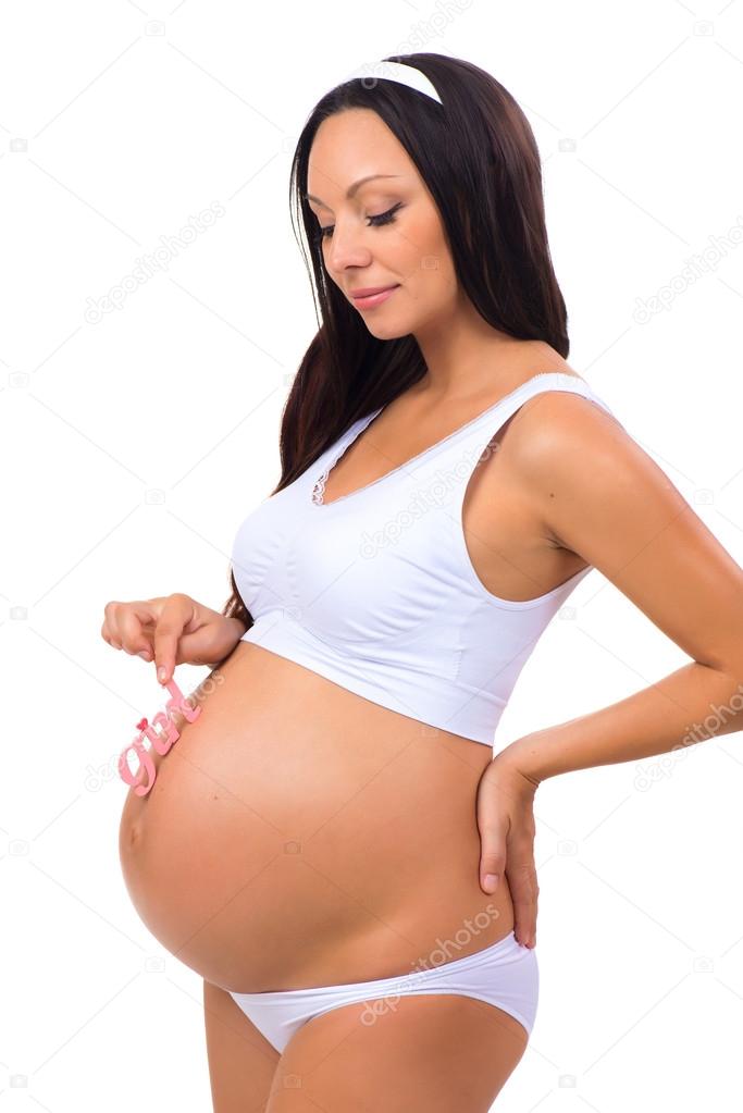 Happy pregnant woman holding near tummy pink label 