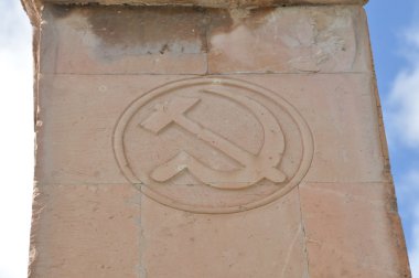Hammer and sickle carved into the tuff clipart