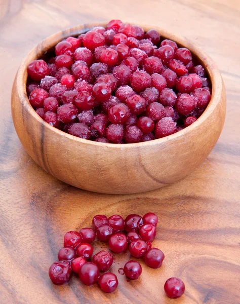 Frozen cowberry in wooden bowl — Stock Photo, Image