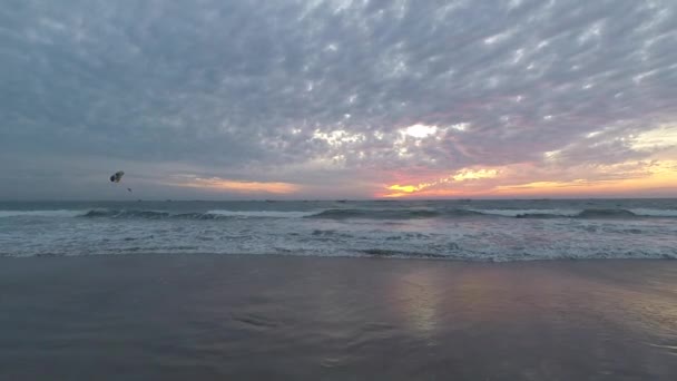 Beautiful sunset on the background of waves on Colva beach in Goa India — Stock Video