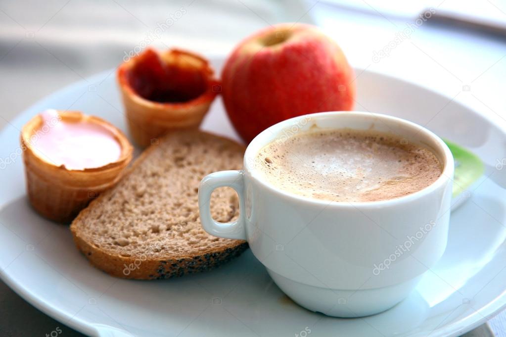 Cup of cappuccino with fruit, yogurt and bread