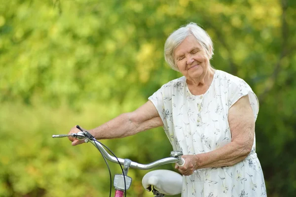 Senior woman with bike — Stock Photo, Image