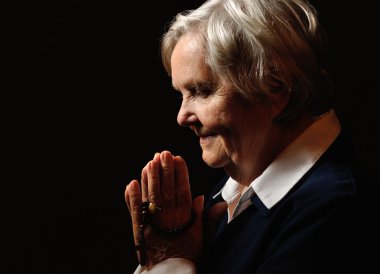 Praying senior woman clipart