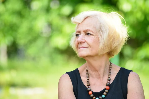 Mature woman in garden — Stock Photo, Image