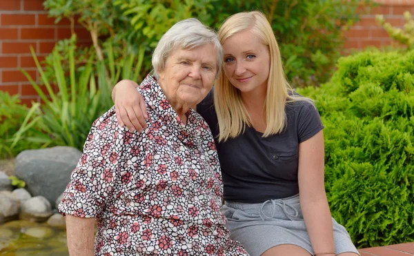 Grandmother and granddaughter in garden