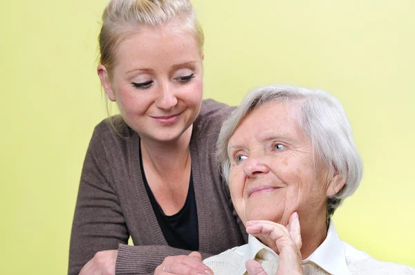 Senior woman with her caregiver.  Happy and smiling. Stock Picture