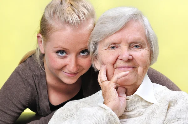 Senior woman with her caregiver.  Happy and smiling. Stock Image