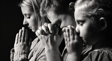 Man, woman and child praying clipart