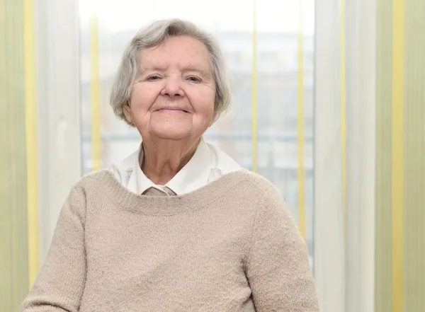 Senior happy woman in her home