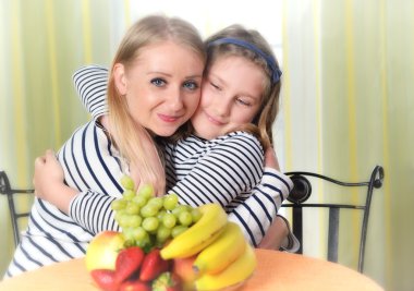 Mother and daughter are hugging each other