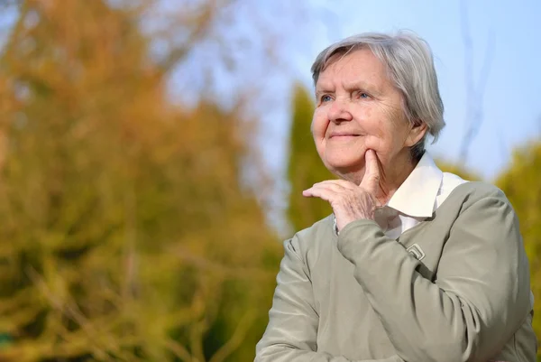 Mujer mirando y sonriendo en el jardín — Foto de Stock