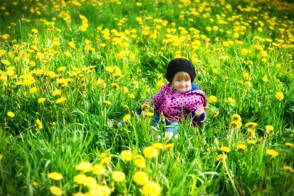 Young girl on meadow with flowers — Stok fotoğraf