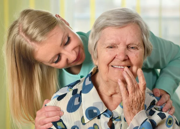 Senior woman with her caregiver Stock Image