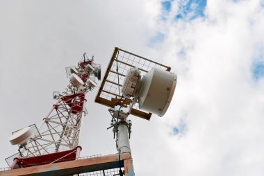 Antenna cellular base station against the blue sky clipart