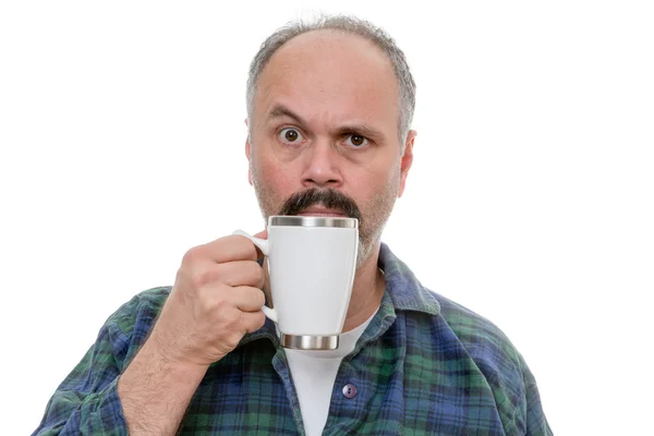 Man with glass near face and puzzled expression — Stock Photo, Image