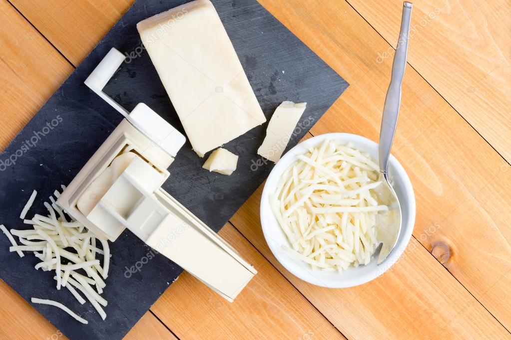 Preparing grated gruyere cheese for cooking