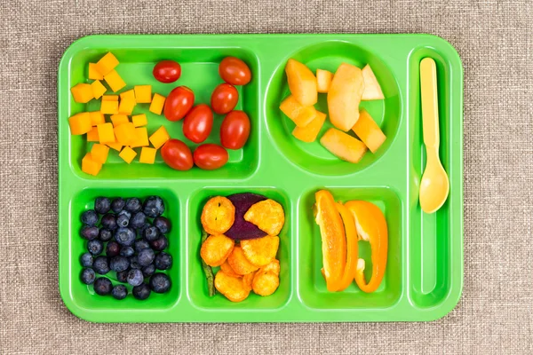 Small plastic lunch tray with fruit and spoon — Stock Photo, Image