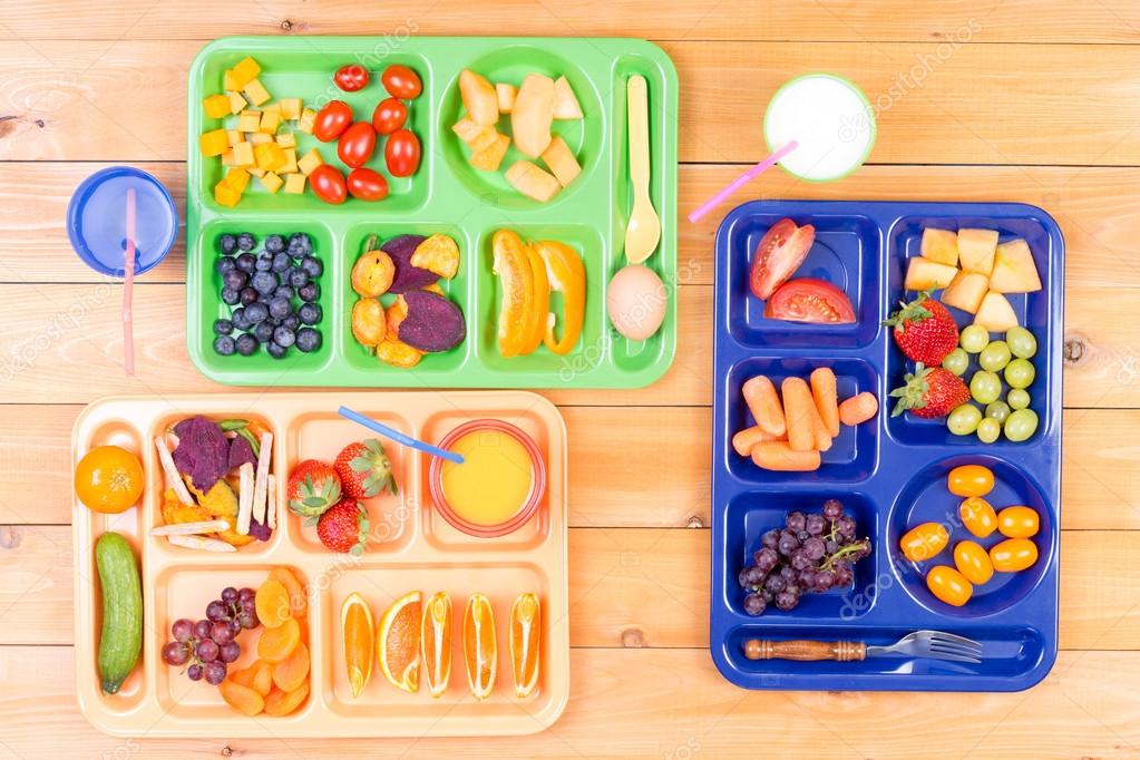 Three colorful lunch trays on table Stock Photo by ©oocoskun 102361070