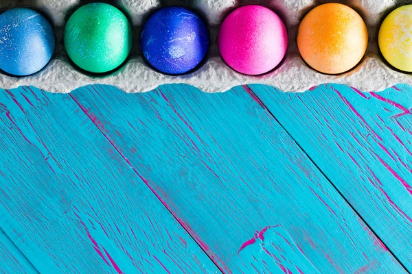 Colorful Easter egg frame on exotic blue copyspace — Stock Photo, Image