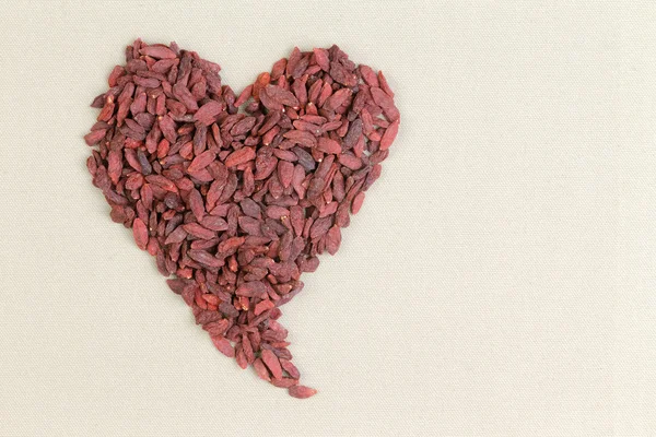 Heart shape formed of healthy dried goji berries — Stock Photo, Image