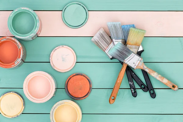 Colorful selection of wood stains and paintbrushes — Stock Photo, Image