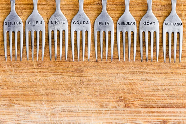 Background of rustic wood table with forks — Stock Photo, Image