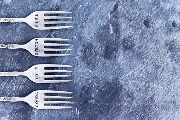 Blue textured background with silver forks — Stock Photo, Image