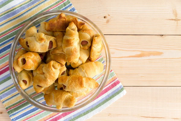 Hot dog filled croissants on a colorful napkin — Stock Photo, Image