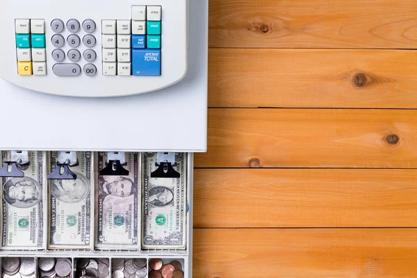 Top down view on cash register full of coins — Stock Photo, Image