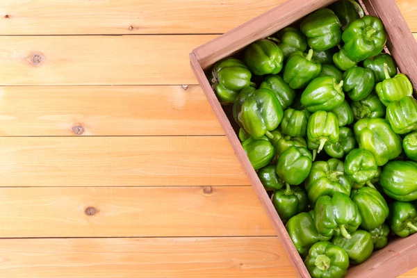 Crate of fresh green peppers from top view — Stock Photo, Image