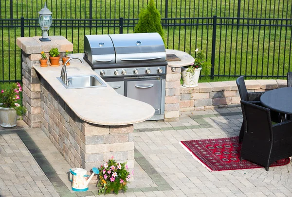 Stylish outdoor kitchen on a brick patio — Stock Photo, Image