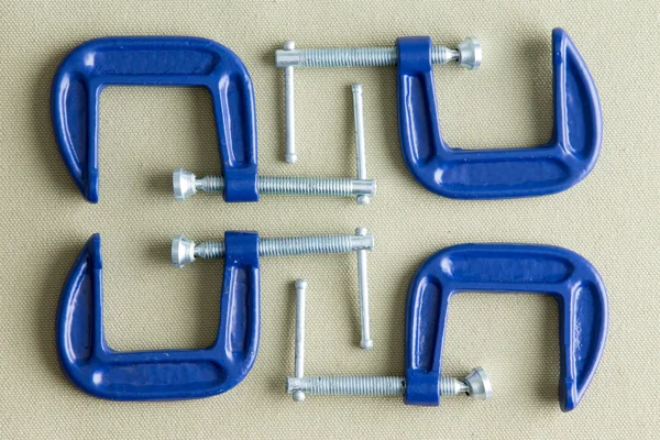 Four blue steel g-clamps — Stock Photo, Image