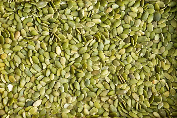 Background texture of green hulled pumpkin seeds — Stock Photo, Image