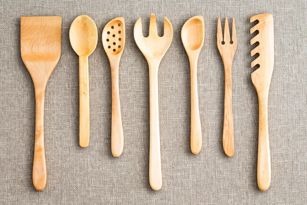 Row of assorted wooden kitchen utensils — Stock Photo, Image