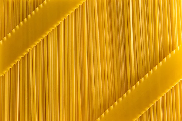 Dried fettuccine pasta and lasagne background — Stock Photo, Image