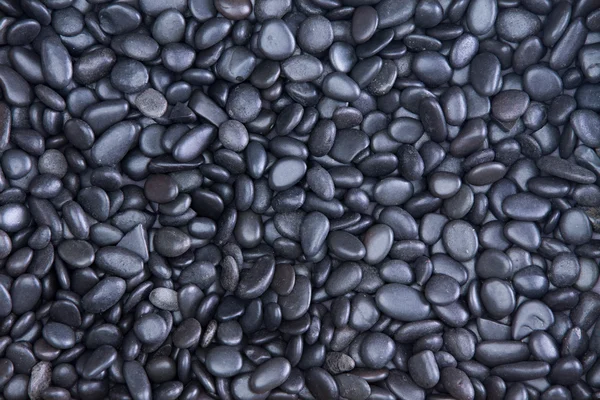 Background texture of waterworn black pebbles — Stock Photo, Image
