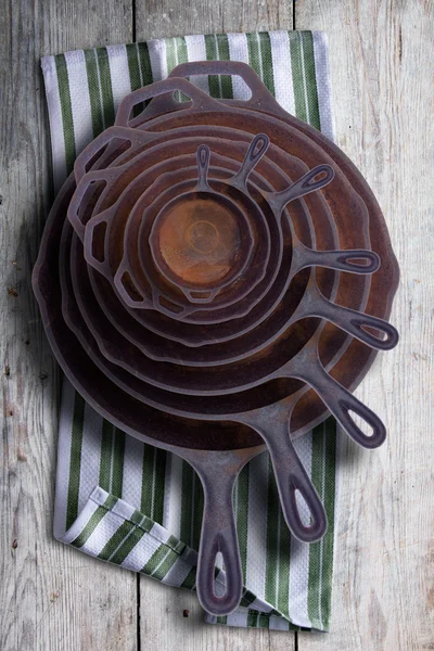Collection of round rusty cast iron frying pans — Stock Photo, Image