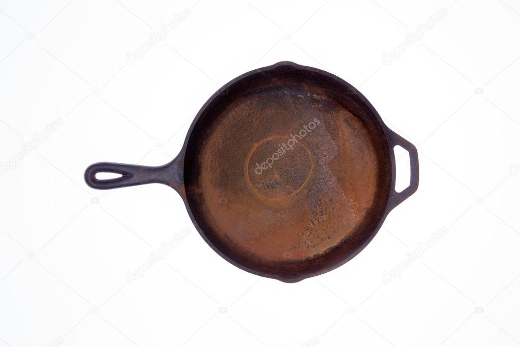 Old rusty round cast iron frying pan